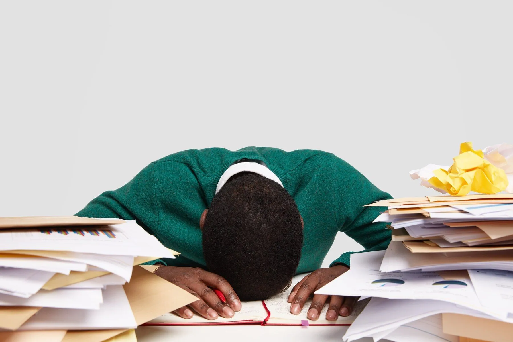 stressful workaholic keeps head down desk feels tired overworked has much work prepares upcoming exam writes information diary 273609 23638