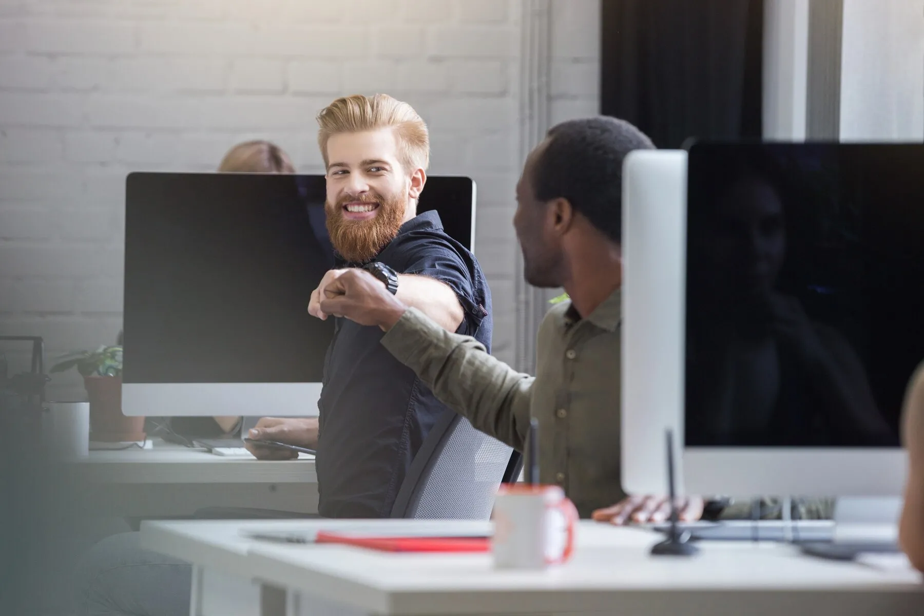 smiling bearded man giving fist bump male colleague 171337 7459
